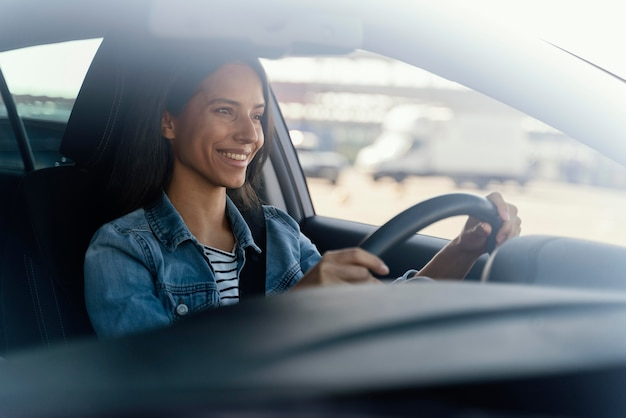 woman smiling while driving a car